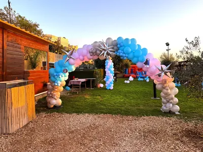 PartyMalta blue, pink and silver themed balloon arch at an outdoor celebration